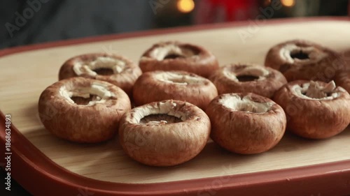 woman’s hands cleaning the bottoms of fresh mushrooms