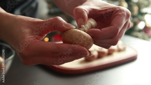 woman’s hands cleaning the bottoms of fresh mushrooms