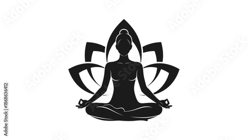 Silhouette of a woman meditating in lotus pose with a lotus flower background.