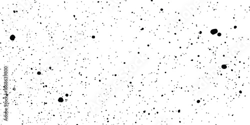 Black speckle and dot texture on a white background creating a seamless grunge pattern. Black and white noise texture with random specks and grain effect for design projects. 