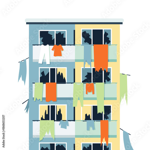 Abandoned building with hanging clothes and broken windows in urban setting  