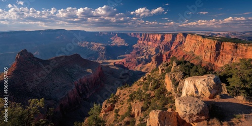 Panoramic vista showcasing the expansive canyon at golden hour light.
