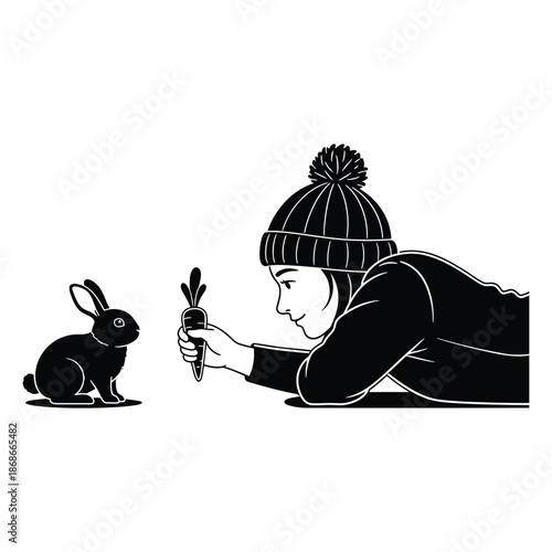 Black silhouette of woman lying down and feeding a carrot to a small rabbit