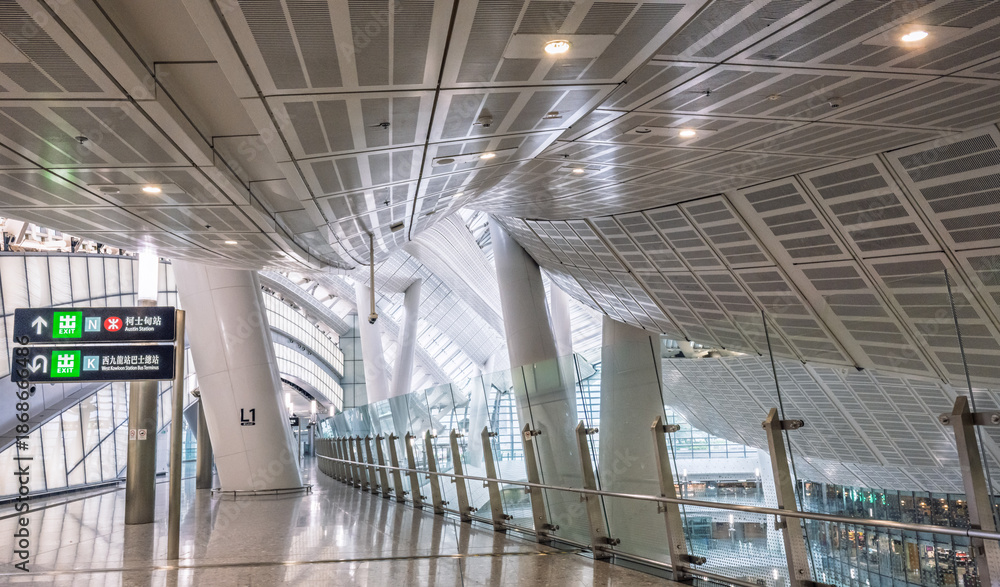 Obraz premium Hong Kong West Kowloon Station, Hong Kong, China, 1 March 2025: interior architectural view of the high speed rail terminal showing curved ceiling structure and glass reflections