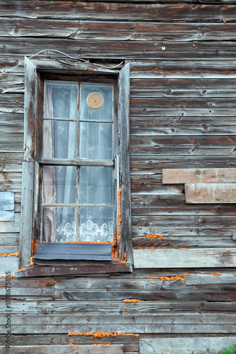 Rustic window reveals weathered texture and vintage facade