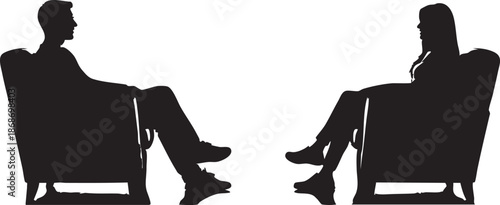 Two people sitting in armchairs facing each other in silhouette