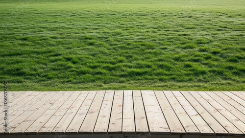 Serene wooden deck overlooking lush green grass