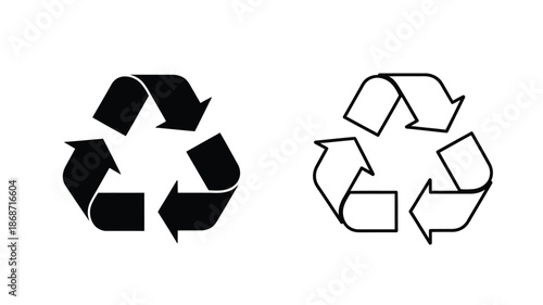 Two recycling symbols one black and one white in a striking silhouette
