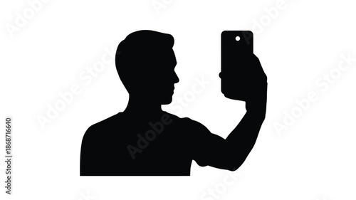 Man taking a selfie with a smartphone a striking black silhouette