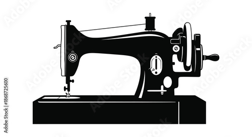 a vintage black sewing machine presented in a striking dark silhouette