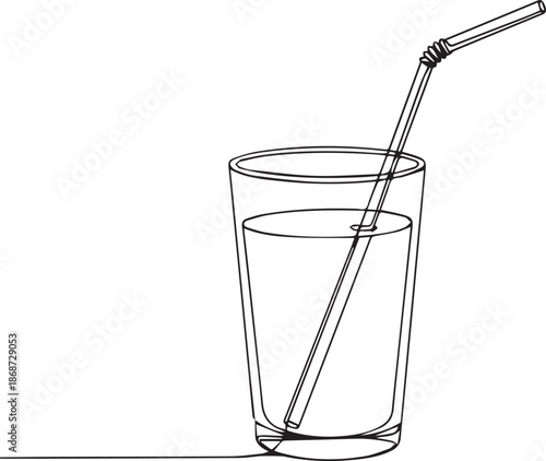 Glass of water with metal straw for refreshing drink