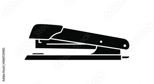 A striking black and white image depicting a classic office stapler in silhouette
