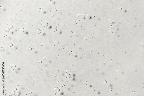 Light Gray textured gel background with bubbles close up. Concept of cosmetic, medical and other laboratory research. Selective focus. Demonstrating color of 2026 year, Cloud, Dancer