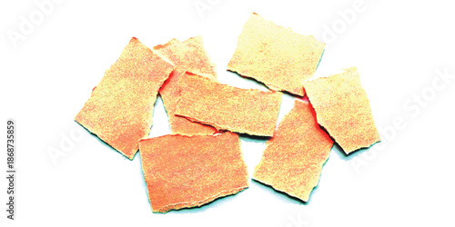 A collection of torn orange paper pieces scattered and isolated on a clean white background