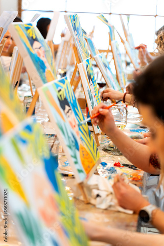 Women enjoying a sip and paint art class