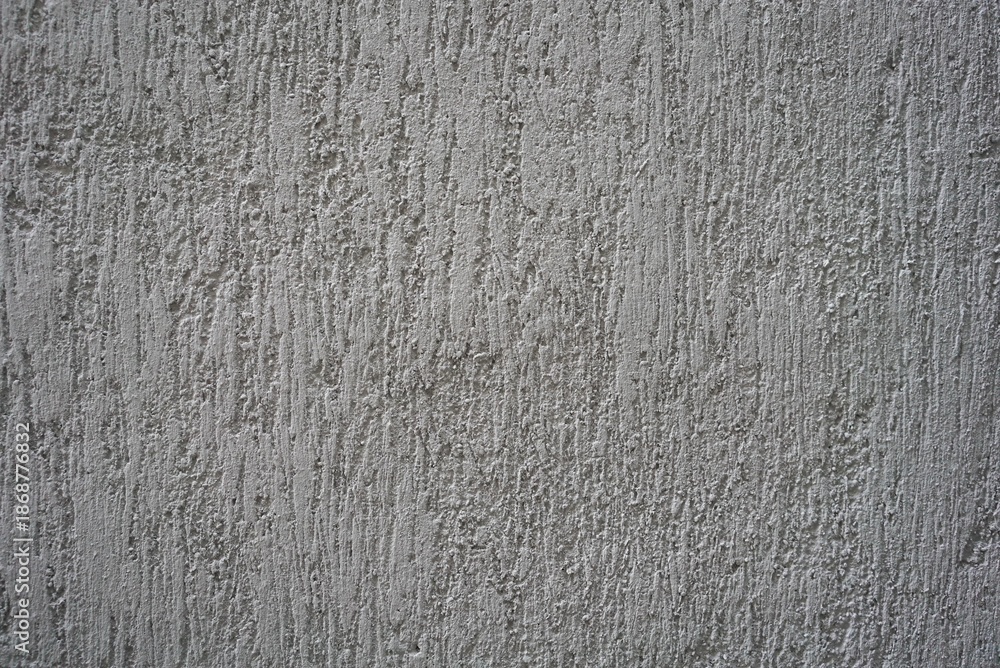 Obraz premium Rough gray concrete wall texture with vertical marks