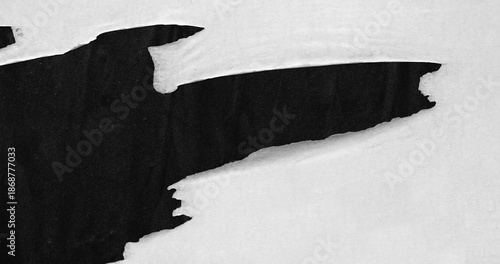 White ripped torn paper on black poster background creased crumpled backdrop surface, blank empty space for text