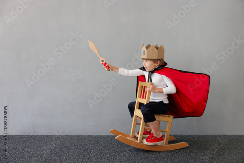 Tableau sur toile Funny child pretend to be knight. Happy kid having fun at home