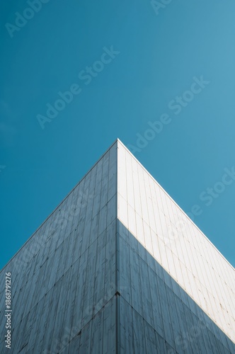 Modern Architecture Stands Against a Clear Blue Sky With Sharp Angles and Sim...