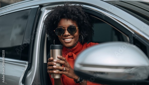 Woman in Sunglasses Holds a Drink While Sitting in a Parked Car During the Day