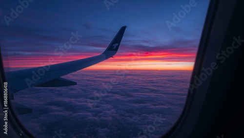 Sunset View From Airplane Window Above Clouds During Flight