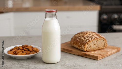 Milk and Almonds Next to Bread on a Kitchen Table in Morning Light