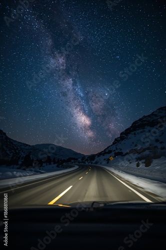Stars Shine Brightly Over a Road During a Winter Night in a Mountain Area