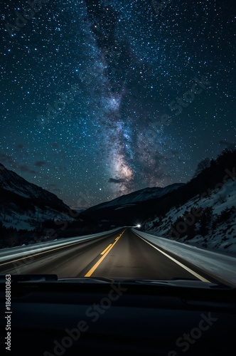 Stars Shine Brightly Over a Road During a Winter Night in a Mountain Area