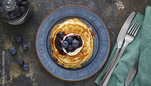 Stack of Pancakes With Jam and Cream Topped With Blueberries on a Plate