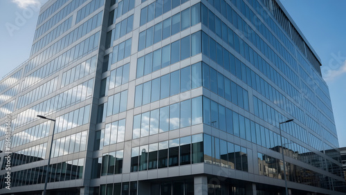Ultra-realistic photo of a modern glass skyscraper reflecting a vibrant sunrise and clouds. Features crisp geometric lines and a clean, corporate aesthetic.