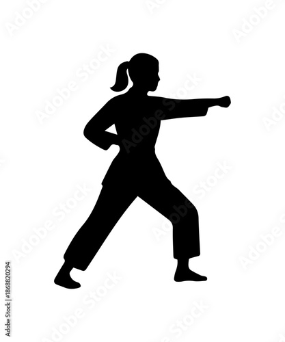Woman silhouette practicing martial arts punch in karate pose