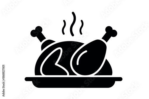Black silhouette of roasted chicken on a platter with steam rising