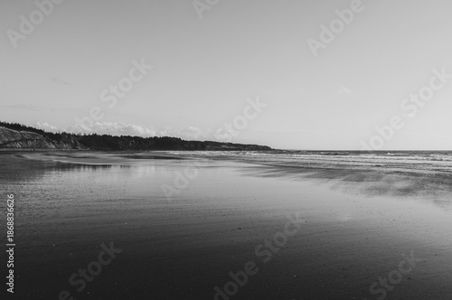 Black and white minimalist shoreline with smooth water, Mavillette Beach Provincial Park, Nova Scotia