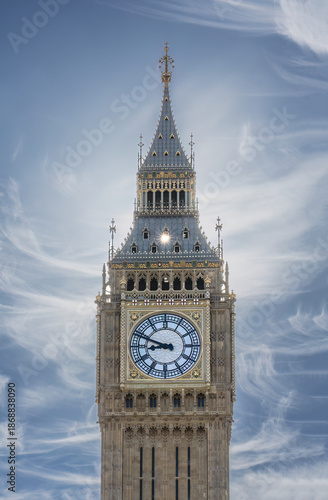 The sun peeks through a small open window near the top of London's famous Big Ben Clock Tower bejeweling the beautiful landmark.