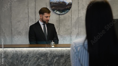 Hotel receptionist welcoming guest at check in counter