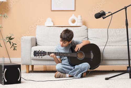 Cute boy playing guitar on ...
