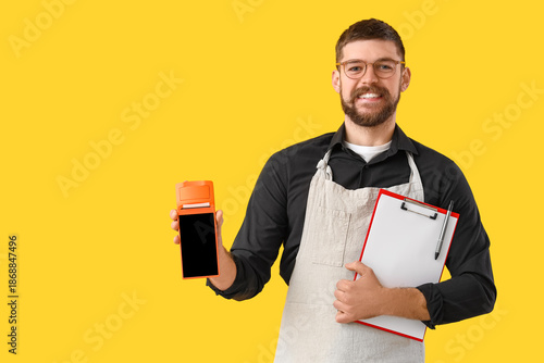 Male barista with payment t...