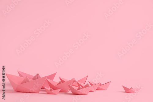 Many origami boats on pink ...