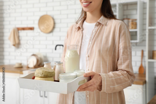 Young woman holding tray wi...