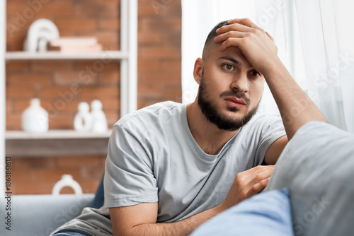 Depressed young man sitting...