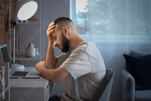 Sad young man sitting near ...