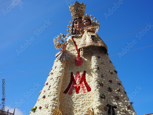 Las Fallas Festival 2025 in Valencia, Spain. A traditional celebration of spring and fire. The Virgin Mary's figure in Plaza de la Virgen, decorated with flowers, after the La Ofrenda procession.