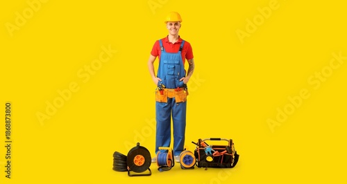 Young male electrician with...