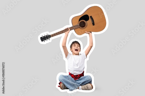 Happy little boy with guita...