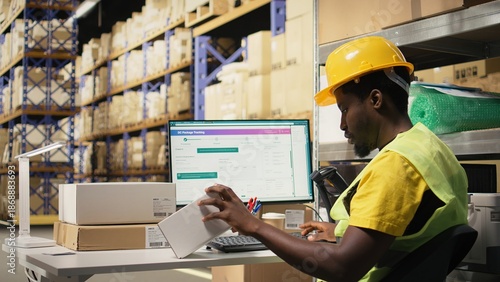 Cuadro en lienzo Black depot clerk reviewing inventory data on tracking software for distribution system, busy logistics hub stock room with organized racks