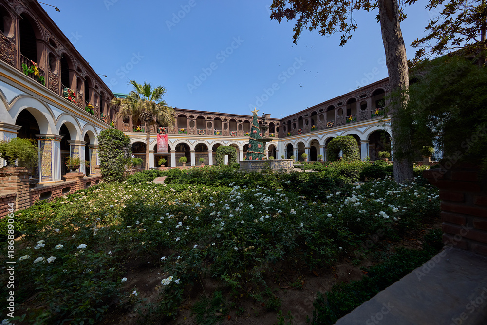 Fototapeta premium Silence and sunlight in the heart of Lima. The Convento de Santo Domingo offers a peaceful escape from the bustling city streets, where centuries of history are preserved in ever