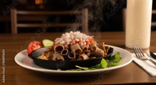 A platter of cooked meat rolls with toppings, garnishes, and a beverage