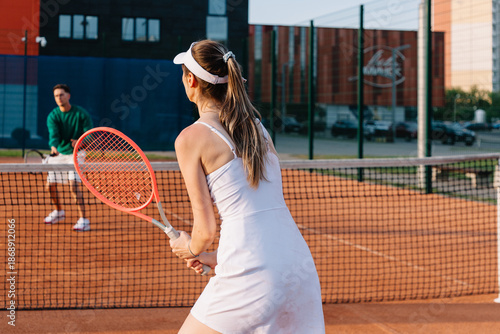 Tennis players compete on a sunny afternoon at a local court