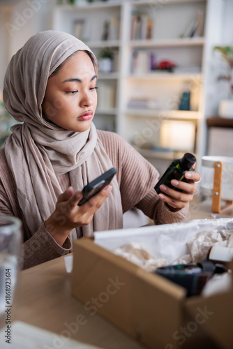 Woman comparing online description with real product