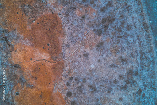 Fotografie Frozen marshland texture and winding animal trail, winter tundra landscape, cold
